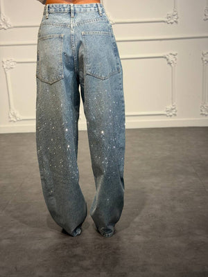 Jeans palazzo con strass degradé e gamba ampia